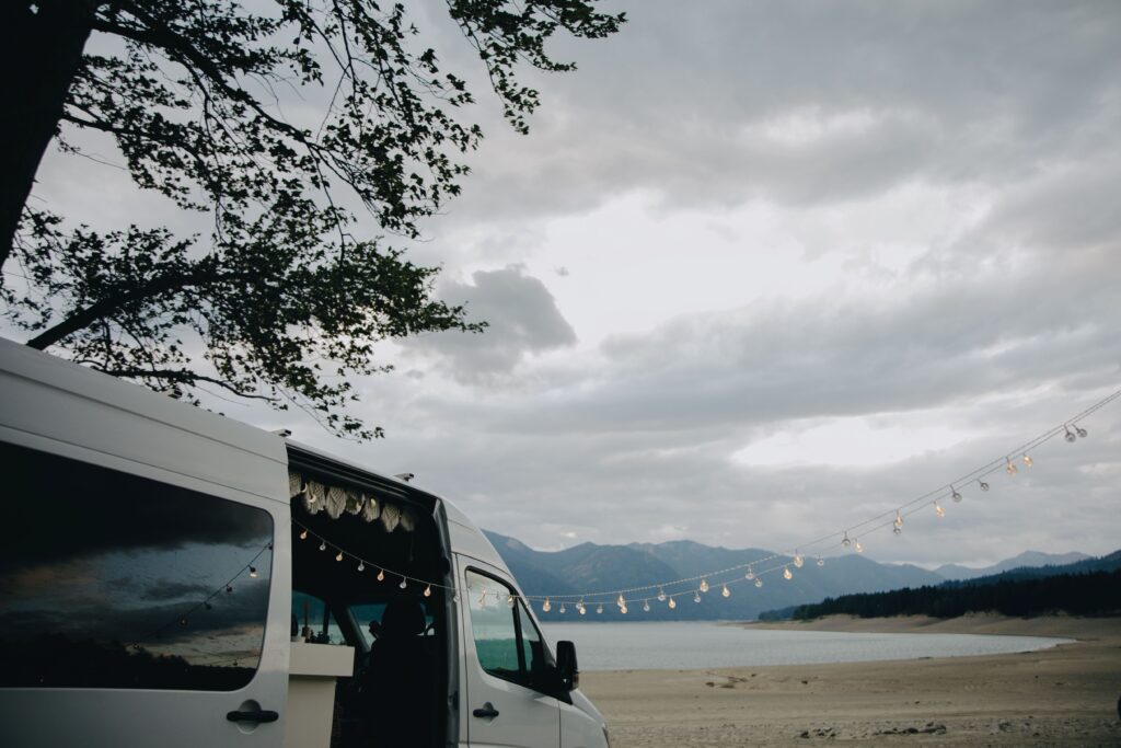 White campervan parked near a body of water