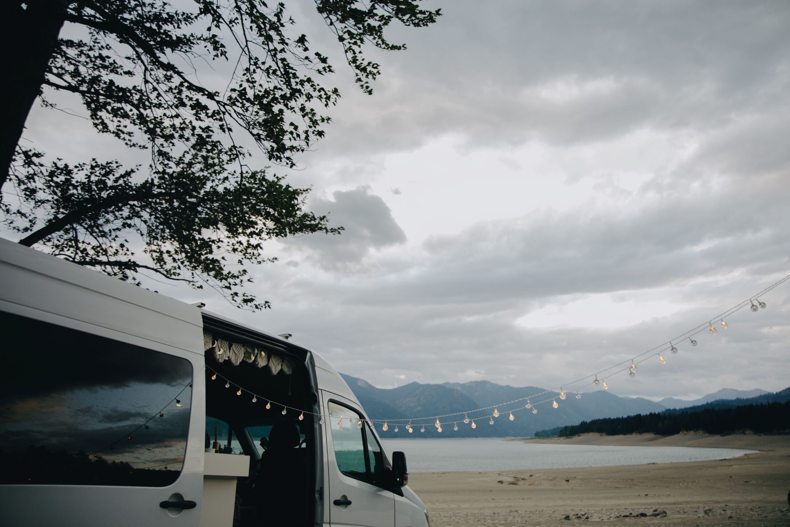 White campervan parked near a body of water